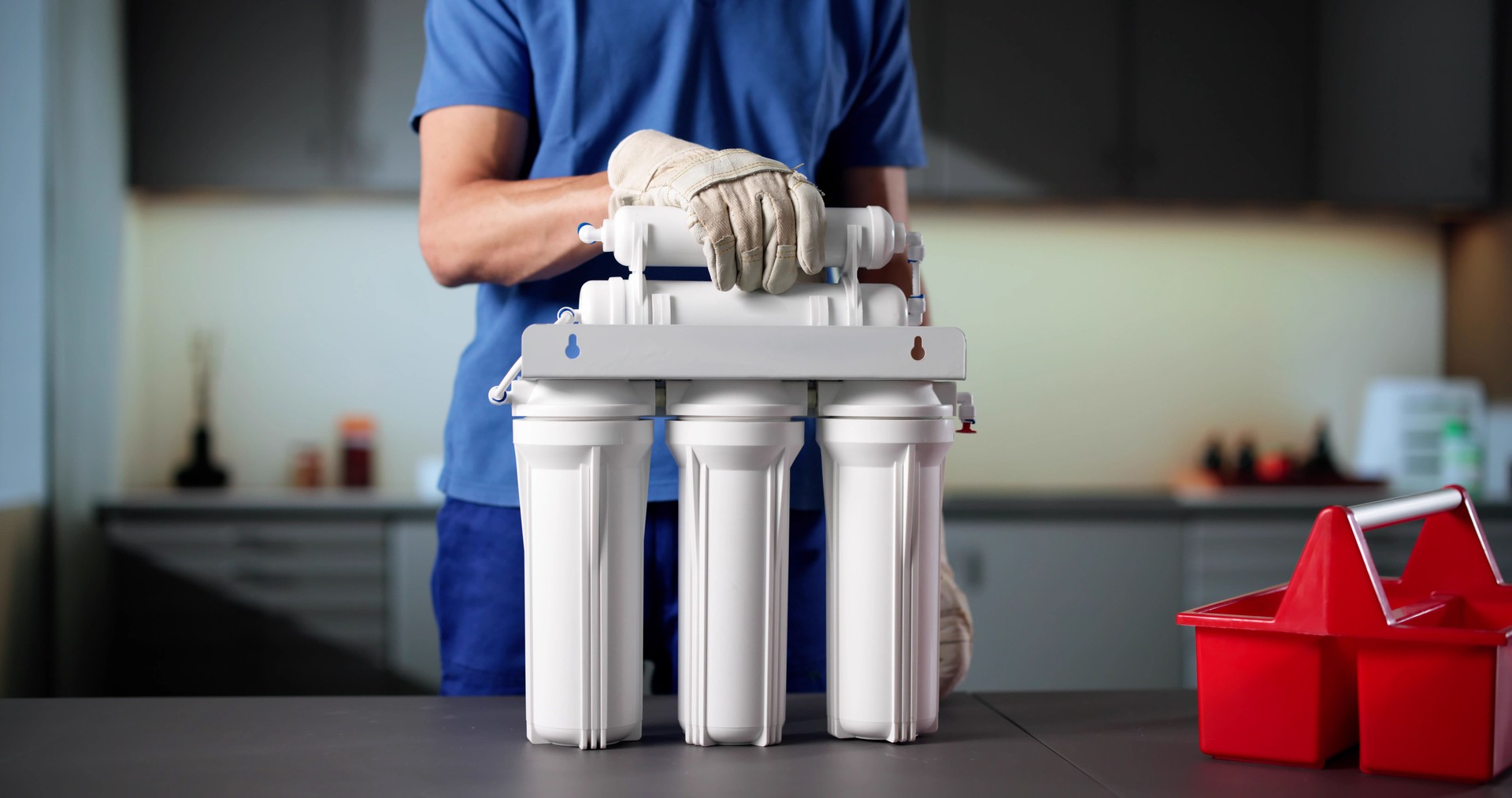 Senior Plumber Installing Water Filter System