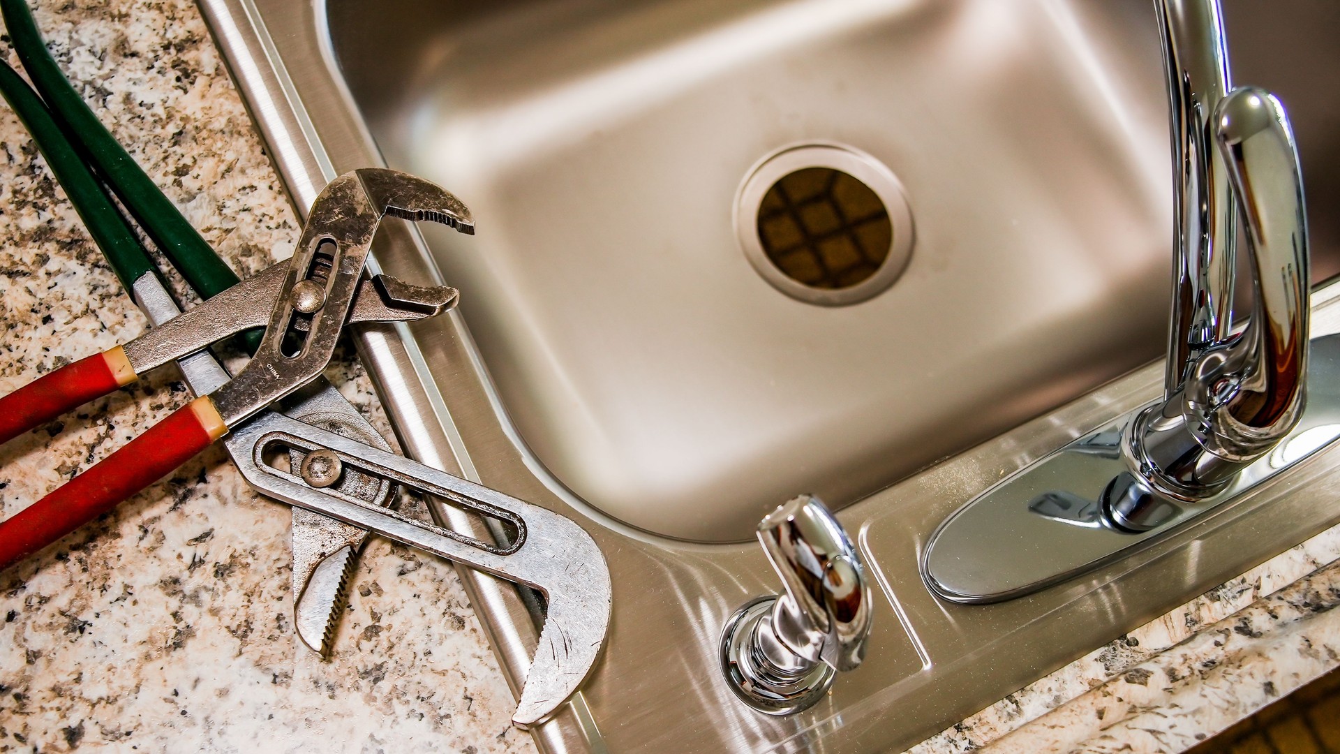 New kitchen sink with pipe wrench key on top